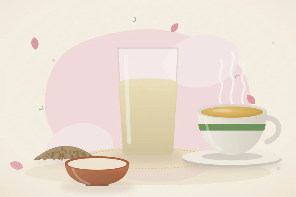 A steel cup of pale golden ajwain water beside a small bowl of ajwain seeds and a wooden spoon on a kitchen table in soft daylight.
