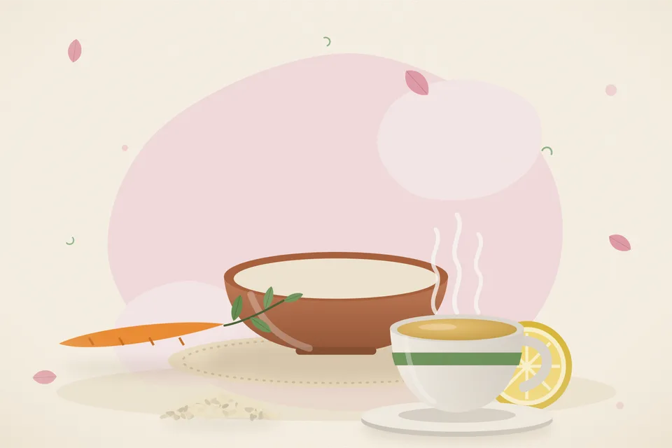 A ceramic bowl of grated beetroot and carrot with lemon wedges and roasted sesame seeds on a wooden kitchen table.