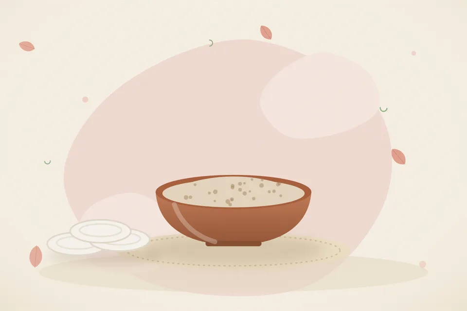 Soaked chironji seeds ground with milk into a pale paste in a small stone bowl