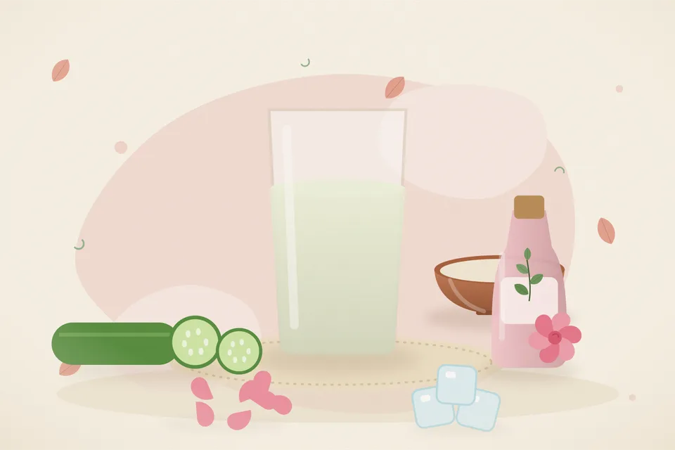 Kitchen still life of a cut cucumber, a glass of strained cucumber juice, and rose water on a steel tray, with no people and no text.