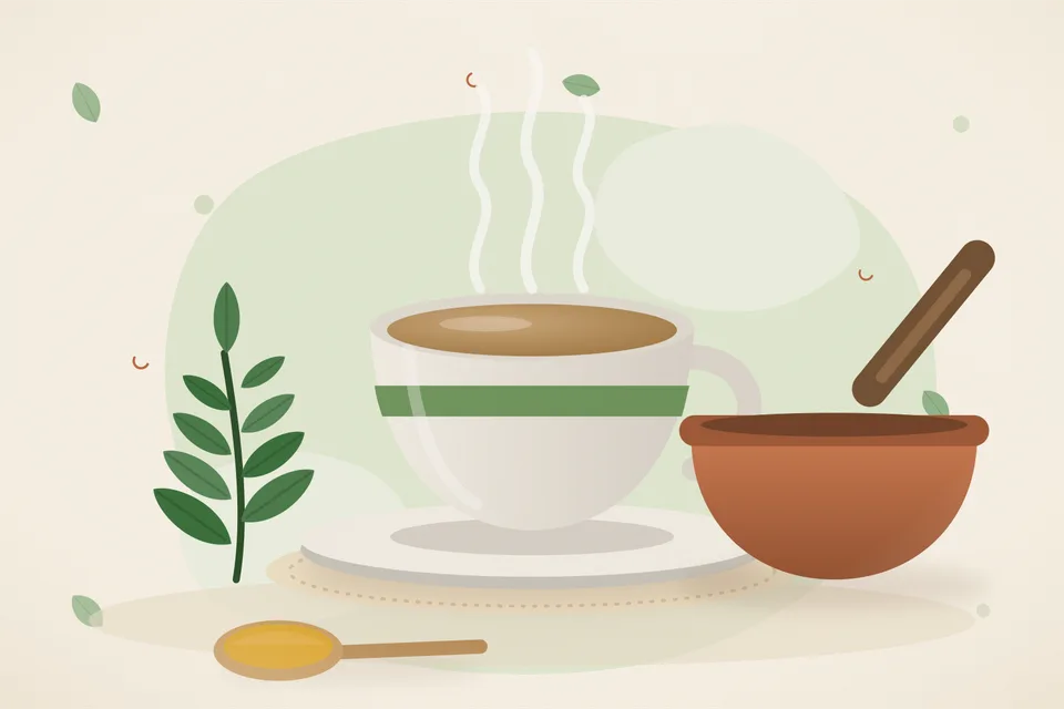 A handful of fresh green curry leaves beside a pale cup of tea and a small steel strainer on a wooden board.