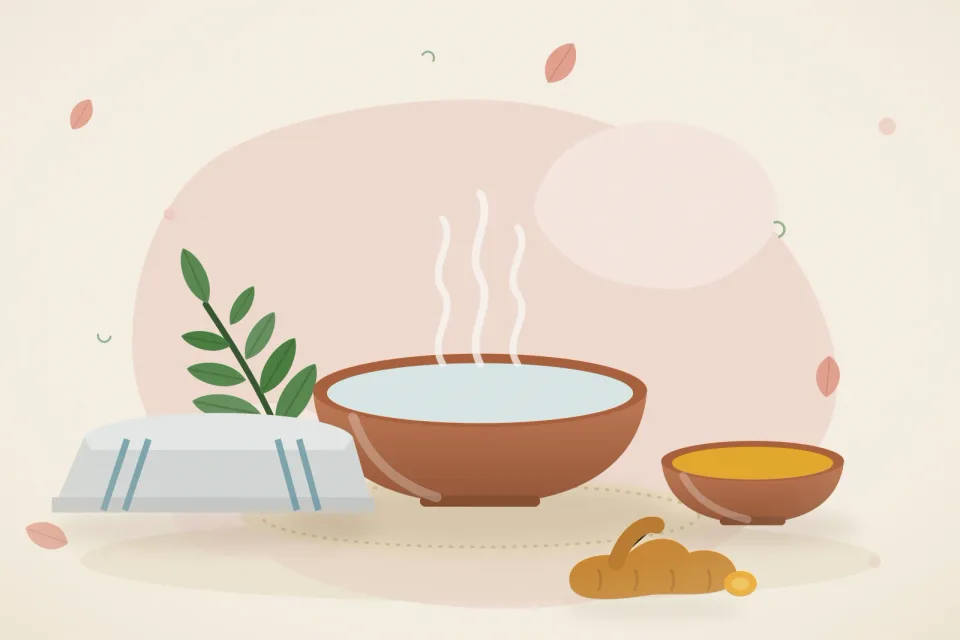 A bowl of warm water with a folded cloth, a small bowl of turmeric paste, neem leaves and fresh turmeric root on a rose-pink background