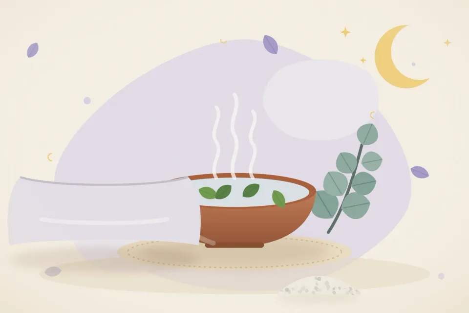 Soft lavender pillow beside a bowl of steaming water with eucalyptus leaves and a crescent moon
