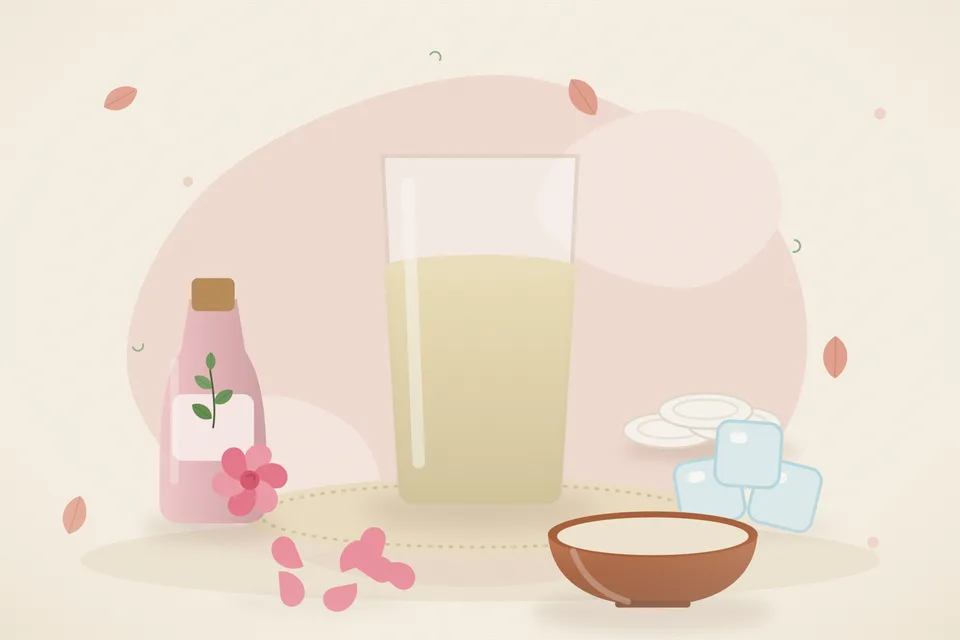 Kitchen still life of rose water in a glass beside an ice tray of frozen rose-water cubes, with no people and no text.
